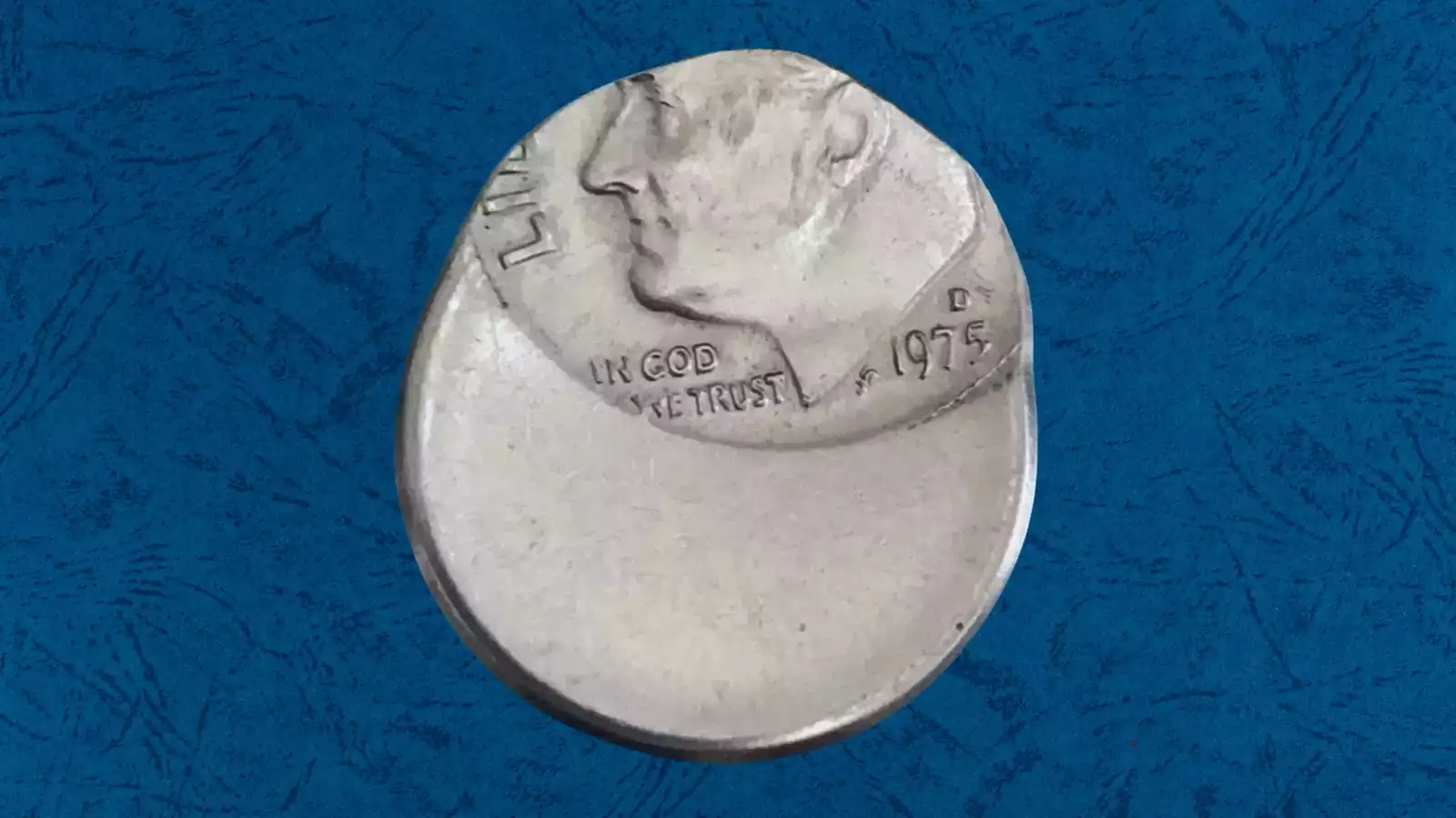 1975 Roosevelt dime off-center strike error showing the design shifted from center with blank planchet visible